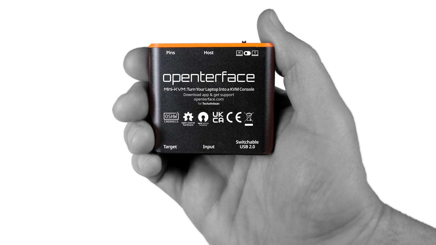 Openterface Mini-KVM adapter shown with scale reference.