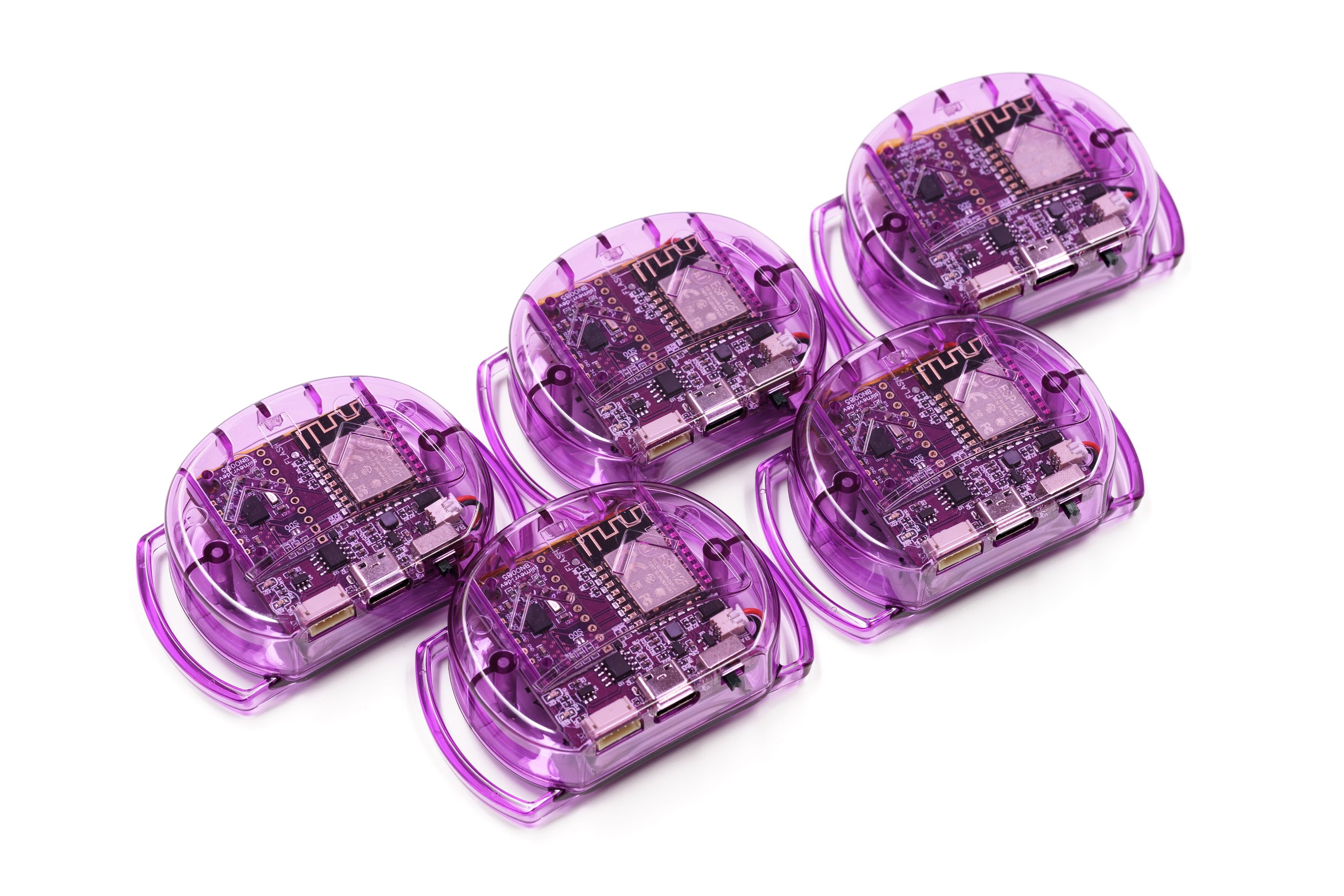 Five SlimeVR trackers arranged on a flat surface.